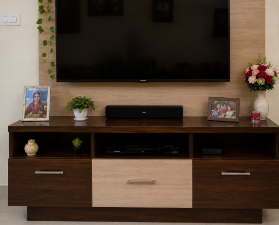 Contemporary Indian Family Living Room with Warm Walnut Entertainment Wall, Cozy Patterned Sofa Seating, Elegant Neutral Interiors, and Functional Everyday Comfort Design gallery